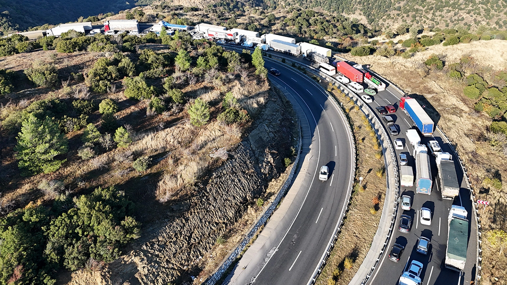 Tır devrildi, yolcu otobüsü bariyere sıkıştı