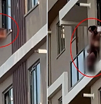 Camdan sarktı: Baş aşağı asılı kaldı